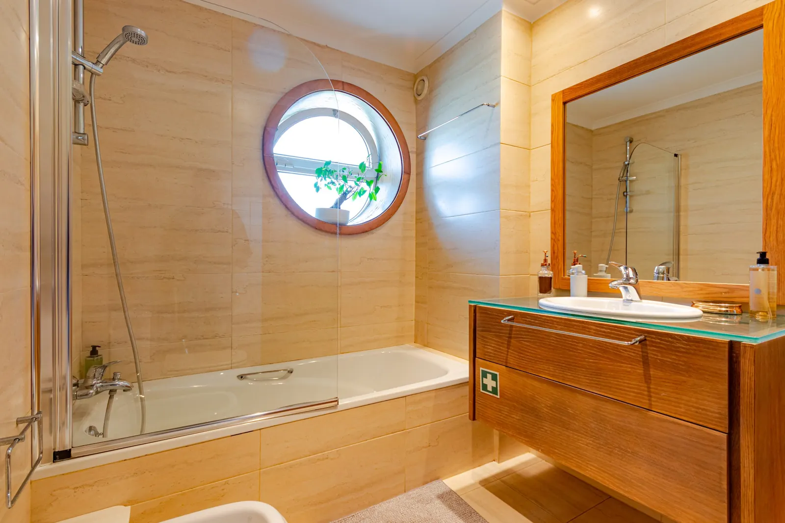 Bathroom with bathtub and round window