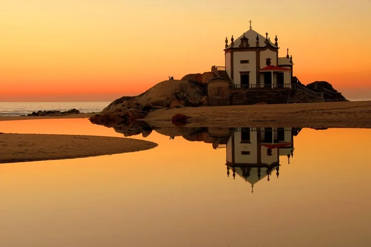 Sunset at the Senhor da Pedra chapel near Miramar beach